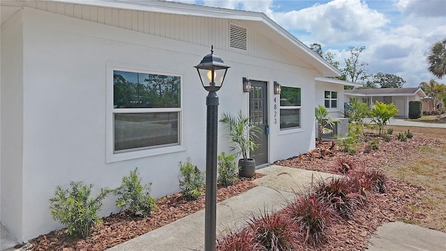 doorway to property with stucco siding