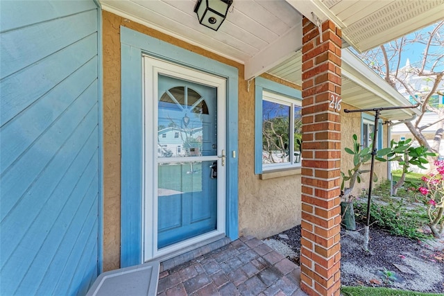 view of exterior entry with covered porch