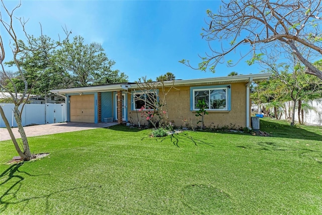 ranch-style house with a garage, stucco siding, fence, a front lawn, and driveway