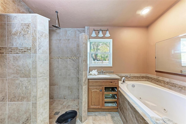 bathroom featuring tile patterned floors, vanity, a whirlpool tub, and walk in shower