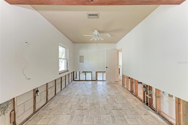 unfurnished room with visible vents, ceiling fan, and stone finish flooring
