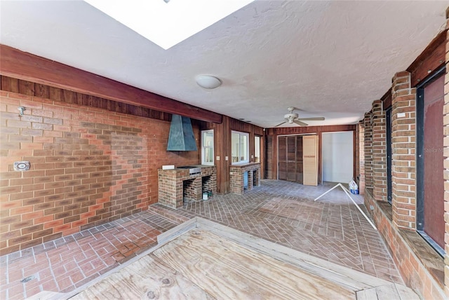 interior space with ceiling fan