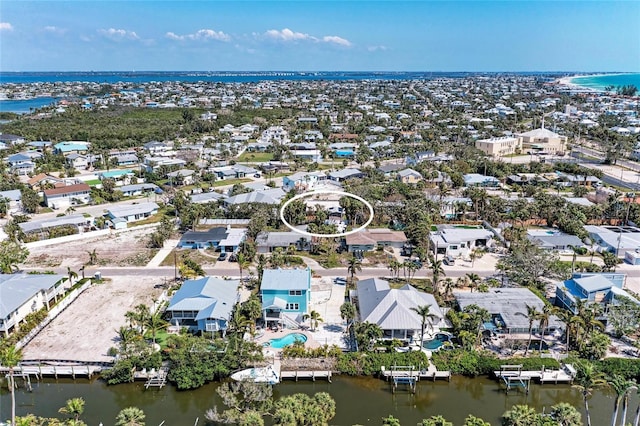 birds eye view of property with a water view and a residential view