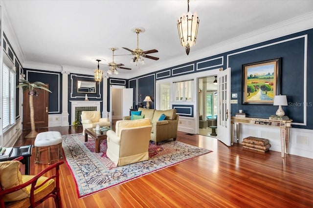 2326 2nd Ave E, Bradenton, FL 34208 - living room with a fireplace, a decorative wall, ornamental molding, wood finished floors, and plenty of natural light