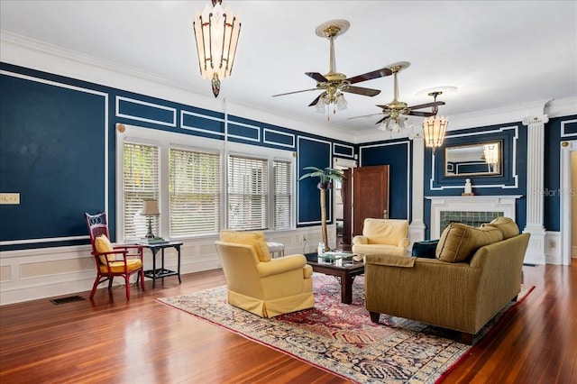 2326 2nd Ave E, Bradenton, FL 34208 - living room featuring a decorative wall, ornamental molding, ceiling fan, wood finished floors, and a tiled fireplace