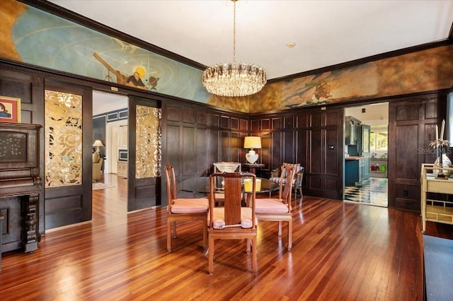 2326 2nd Ave E, Bradenton, FL 34208 - dining room featuring hardwood / wood-style flooring, a chandelier, a decorative wall, and ornamental molding