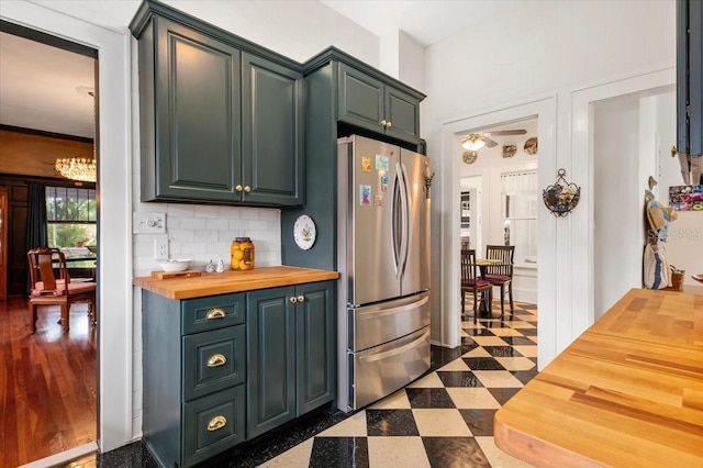 2326 2nd Ave E, Bradenton, FL 34208 - kitchen with freestanding refrigerator, wooden counters, dark floors, ceiling fan, and decorative backsplash