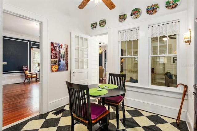2326 2nd Ave E, Bradenton, FL 34208 - dining space featuring tile patterned floors, ceiling fan, a decorative wall, a wainscoted wall, and baseboards
