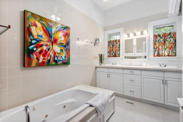 2326 2nd Ave E, Bradenton, FL 34208 - full bath featuring tile patterned floors, double vanity, a whirlpool tub, and plenty of natural light