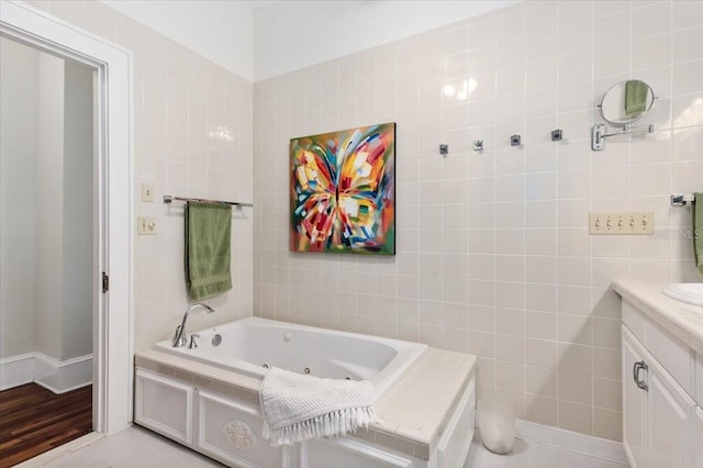 2326 2nd Ave E, Bradenton, FL 34208 - full bath featuring vanity, a whirlpool tub, tile walls, and wood finished floors