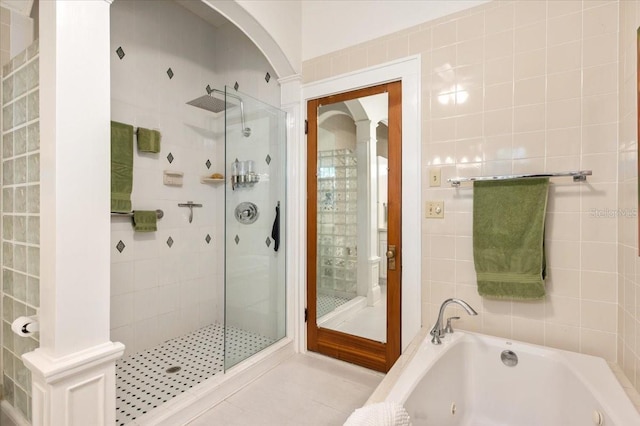 2326 2nd Ave E, Bradenton, FL 34208 - bathroom with a shower stall, a jetted tub, and tile patterned floors
