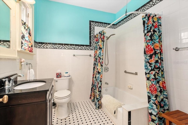 2326 2nd Ave E, Bradenton, FL 34208 - bathroom with tile walls, toilet, shower / bathtub combination with curtain, and vanity