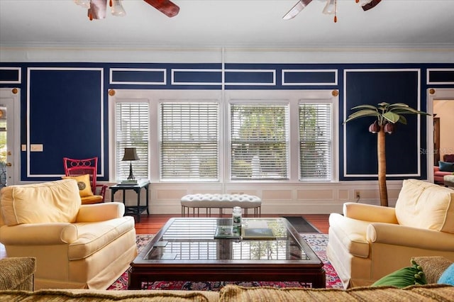 2326 2nd Ave E, Bradenton, FL 34208 - living room featuring ceiling fan, a decorative wall, ornamental molding, and wood finished floors