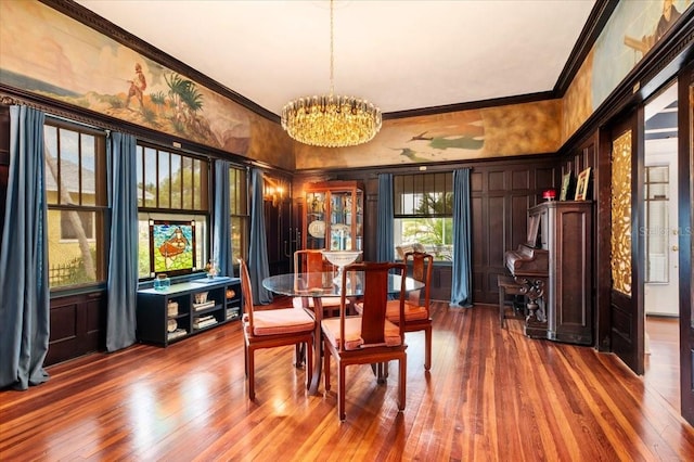 2326 2nd Ave E, Bradenton, FL 34208 - dining room featuring crown molding, a chandelier, a decorative wall, and dark wood-style flooring