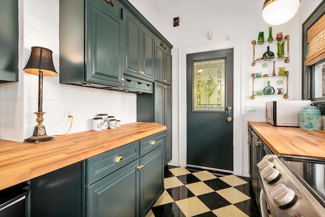 2326 2nd Ave E, Bradenton, FL 34208 - kitchen featuring butcher block counters, stainless steel appliances, light flooring, and tasteful backsplash