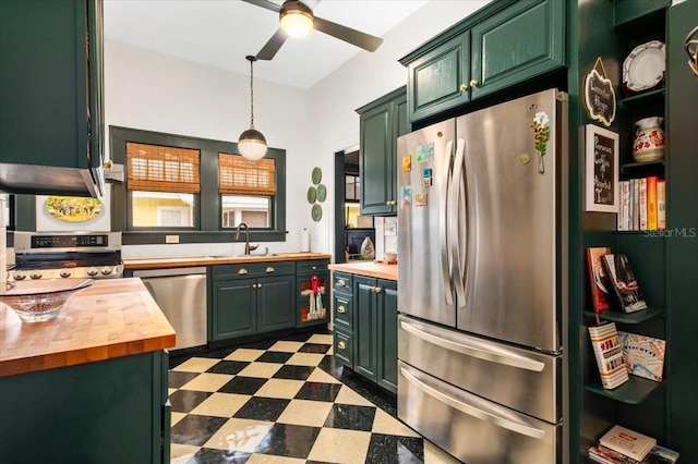 2326 2nd Ave E, Bradenton, FL 34208 - kitchen featuring stainless steel appliances, wooden counters, dark flooring, a sink, and green cabinetry
