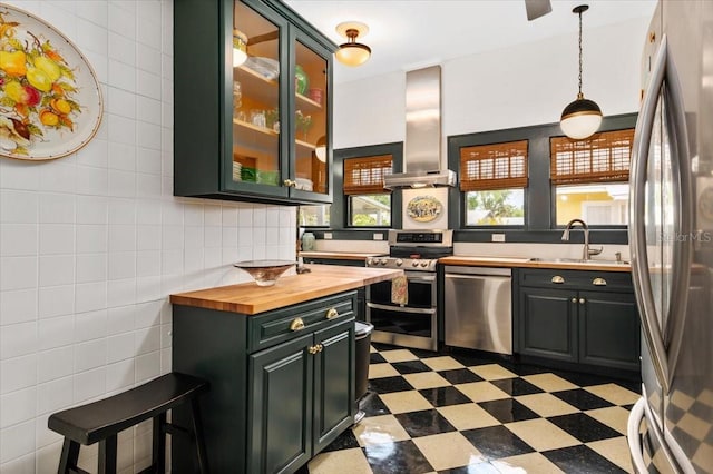 2326 2nd Ave E, Bradenton, FL 34208 - kitchen featuring stainless steel appliances, wood counters, a sink, tile patterned floors, and wall chimney range hood