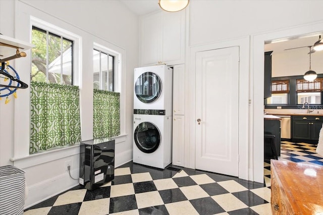 2326 2nd Ave E, Bradenton, FL 34208 - laundry room with stacked washing machine and dryer and dark flooring