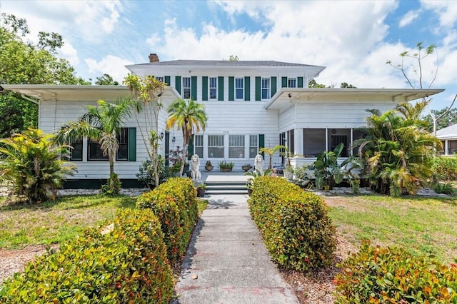 2326 2nd Ave E, Bradenton, FL 34208 - view of front of home with a chimney and a sunroom