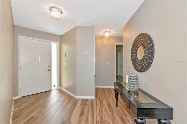 1712 Starling Dr Unit 101, Sarasota, FL 34231 - foyer entrance featuring baseboards and light wood finished floors