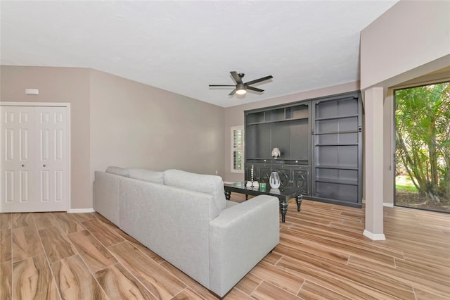 1712 Starling Dr Unit 101, Sarasota, FL 34231 - living room featuring wood tiled floor, baseboards, and a ceiling fan