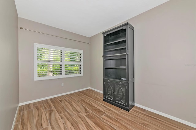 1712 Starling Dr Unit 101, Sarasota, FL 34231 - empty room featuring baseboards and light wood-type flooring