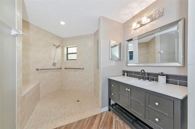 1712 Starling Dr Unit 101, Sarasota, FL 34231 - full bath featuring vanity, tiled shower, and wood finished floors