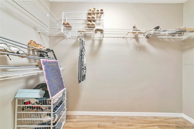 1712 Starling Dr Unit 101, Sarasota, FL 34231 - walk in closet with wood finished floors