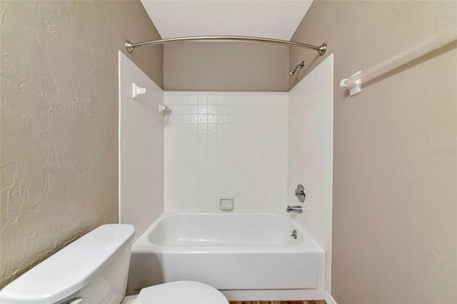 1712 Starling Dr Unit 101, Sarasota, FL 34231 - bathroom with toilet, a textured wall, and bathtub / shower combination