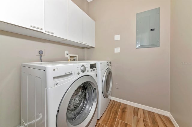 1712 Starling Dr Unit 101, Sarasota, FL 34231 - laundry room with separate washer and dryer, baseboards, electric panel, and cabinet space