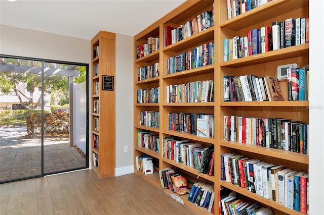 1712 Starling Dr Unit 101, Sarasota, FL 34231 - living area with wall of books and wood finished floors