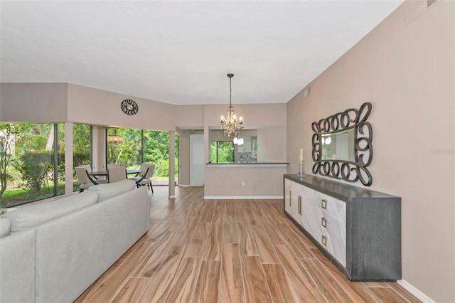 1712 Starling Dr Unit 101, Sarasota, FL 34231 - interior space featuring light wood-style floors, baseboards, an inviting chandelier, and visible vents