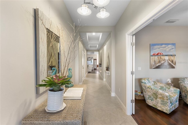 6936 White Willow Ct, Sarasota, FL 34243 - hallway with tile patterned floors, visible vents, and baseboards