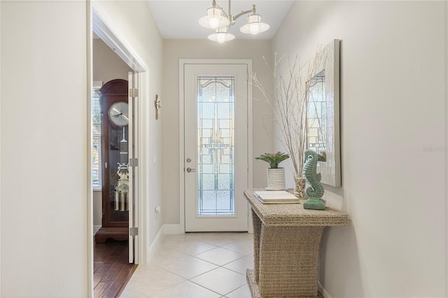 6936 White Willow Ct, Sarasota, FL 34243 - doorway with a notable chandelier, baseboards, and a healthy amount of sunlight