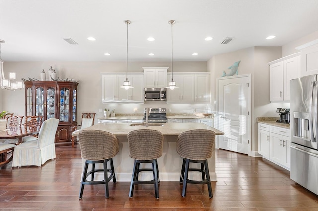 6936 White Willow Ct, Sarasota, FL 34243 - kitchen featuring stainless steel appliances, dark wood-type flooring, visible vents, and a sink