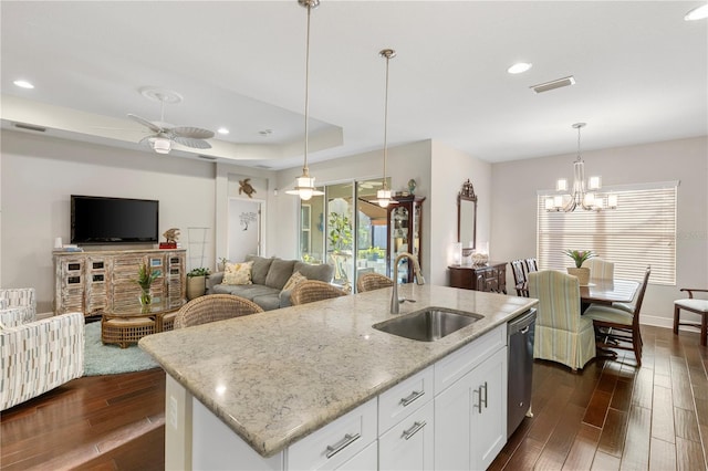 6936 White Willow Ct, Sarasota, FL 34243 - kitchen featuring visible vents, hanging light fixtures, a sink, dark wood finished floors, and light stone counters