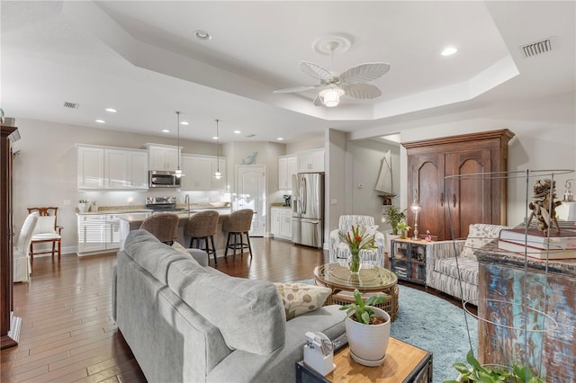 6936 White Willow Ct, Sarasota, FL 34243 - living room with hardwood / wood-style floors, ceiling fan, visible vents, and recessed lighting