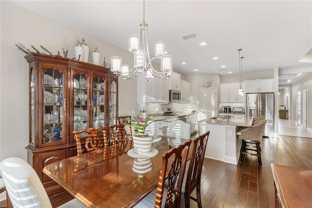 6936 White Willow Ct, Sarasota, FL 34243 - dining space with dark wood-style flooring, visible vents, recessed lighting, and a chandelier