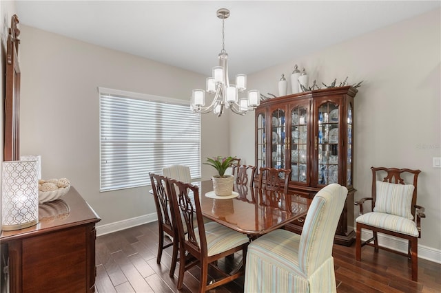 6936 White Willow Ct, Sarasota, FL 34243 - dining area featuring a notable chandelier, dark wood finished floors, and baseboards
