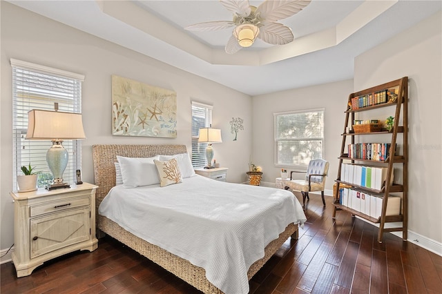6936 White Willow Ct, Sarasota, FL 34243 - bedroom with a raised ceiling, ceiling fan, baseboards, and dark wood finished floors
