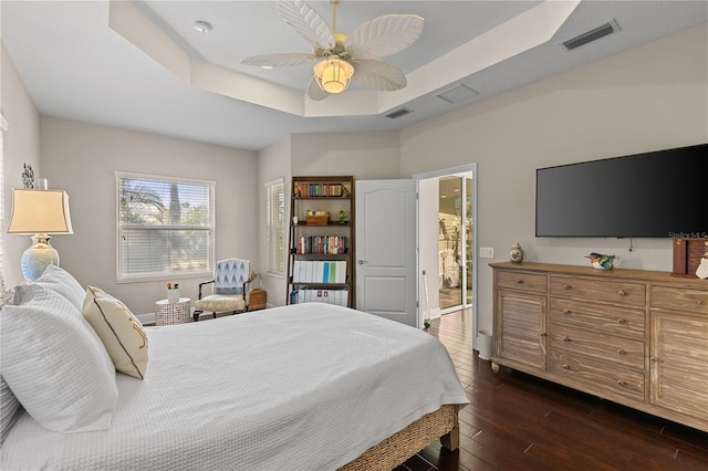 6936 White Willow Ct, Sarasota, FL 34243 - bedroom with visible vents, ceiling fan, a raised ceiling, and dark wood-style floors
