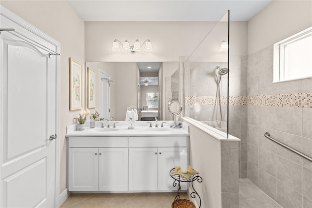 6936 White Willow Ct, Sarasota, FL 34243 - ensuite bathroom featuring a walk in shower, tile patterned floors, double vanity, and a sink