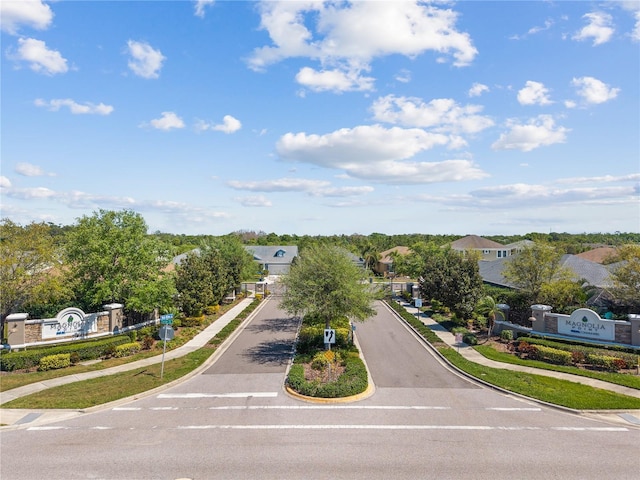 6936 White Willow Ct, Sarasota, FL 34243 - exterior space featuring curbs, a gated entry, traffic signs, sidewalks, and a residential view