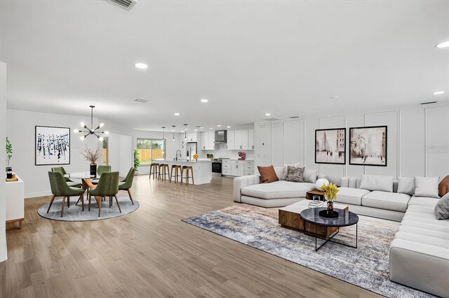 2881 48th Way E, Bradenton, FL 34203 - living room with recessed lighting, light wood-style floors, and a chandelier