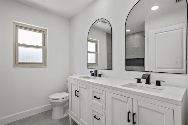 2881 48th Way E, Bradenton, FL 34203 - full bathroom featuring double vanity, toilet, baseboards, and a sink