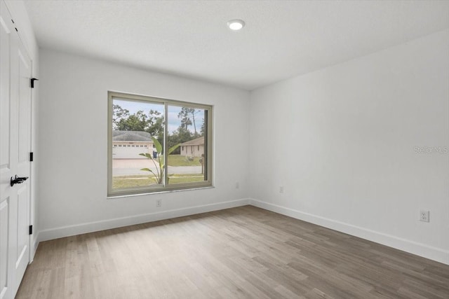 2881 48th Way E, Bradenton, FL 34203 - unfurnished room with baseboards, wood finished floors, and recessed lighting