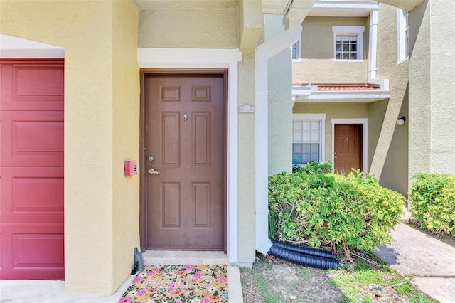 property entrance with stucco siding