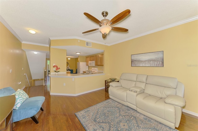 living area with a ceiling fan, baseboards, crown molding, and light wood finished floors