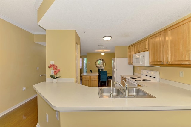 kitchen with a textured ceiling, a sink, white appliances, light countertops, and a peninsula