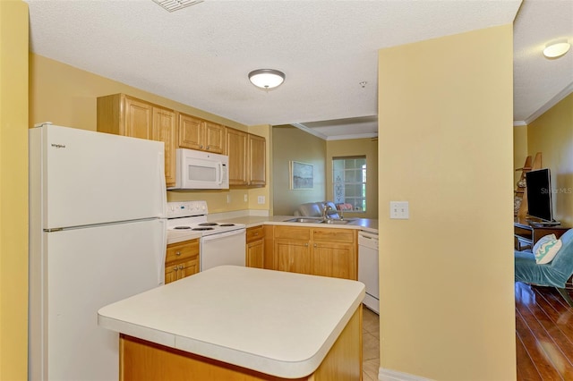 kitchen featuring crown molding, a textured ceiling, a sink, white appliances, and light countertops